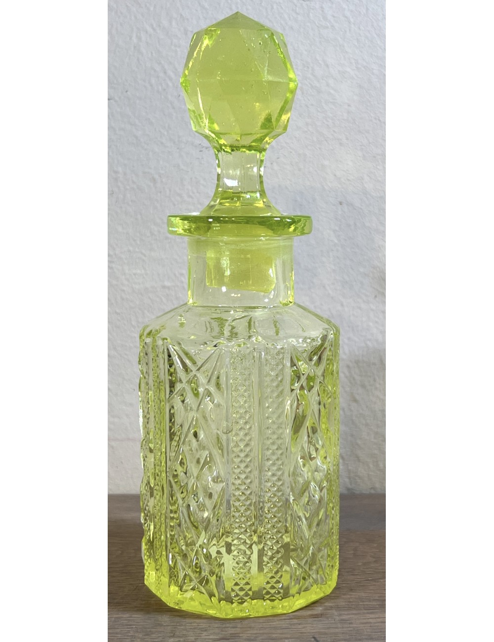 Perfume carafe with stopper - part of a dressing table set - executed in uranium glass/Annagreen glass