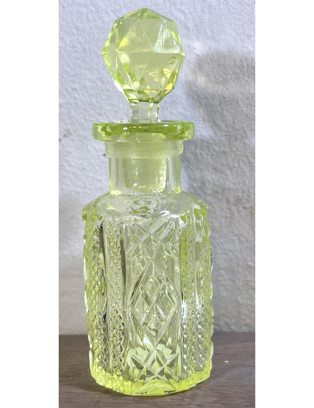 Perfume carafe with stopper - part of a dressing table set - executed in uranium glass/Annagreen glass