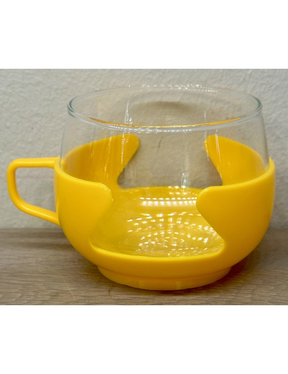 Tea glass in yellow coloured plastic holder - unmarked - 1970s