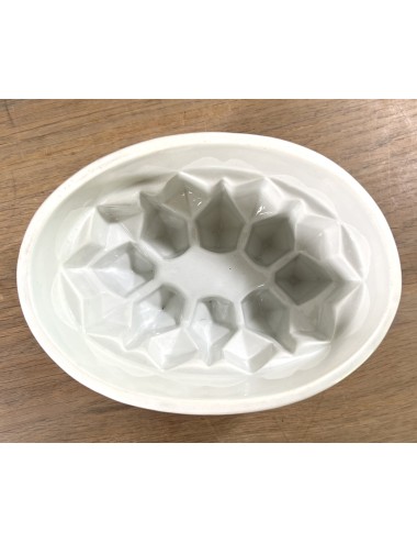 Pudding mould - large white porcelain model with angular motif incorporated in bottom