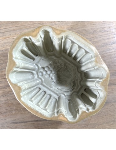 Pudding mould - earthenware/ceramic model executed in brown/grey with grape design on the bottom